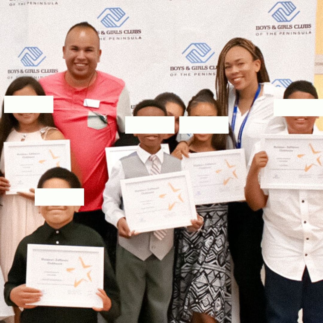 Image of a man, a woman, Taryn Allyssa, and students holding certificates, dressed in nice clothing. 